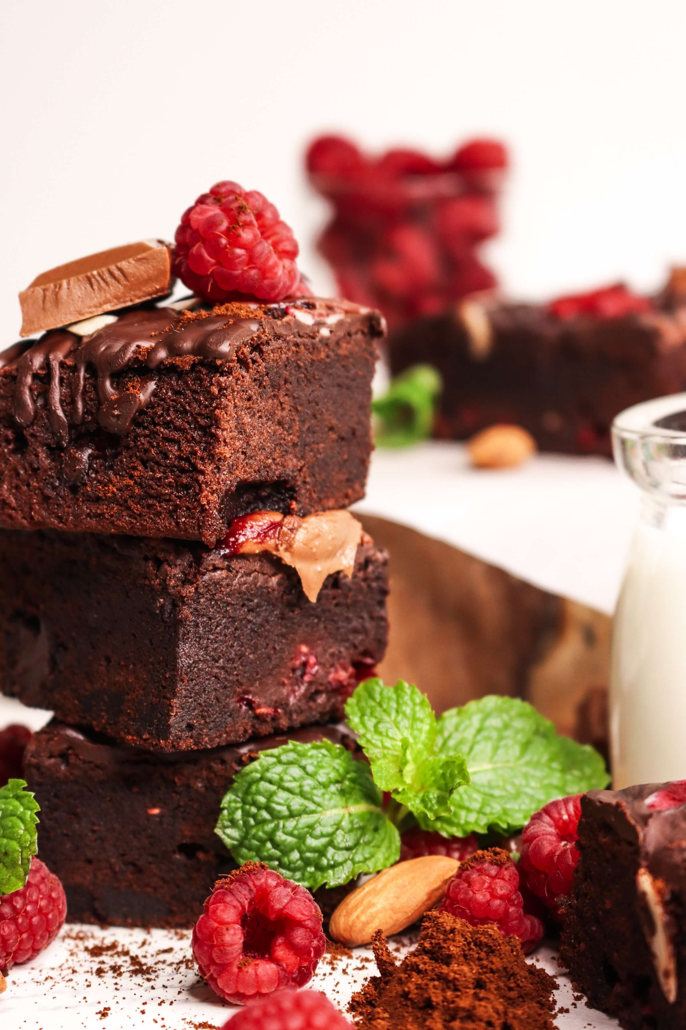 stack of brownies with raspberries and mint leaves