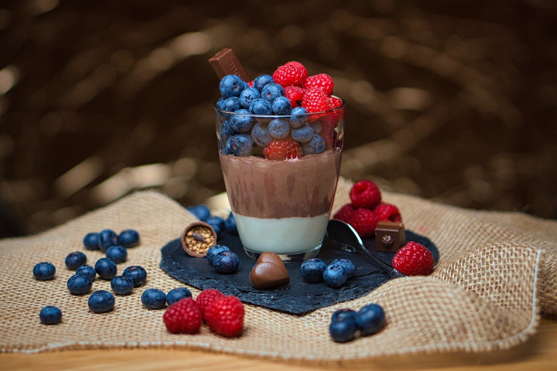 Chocolate pudding in a glass with berries