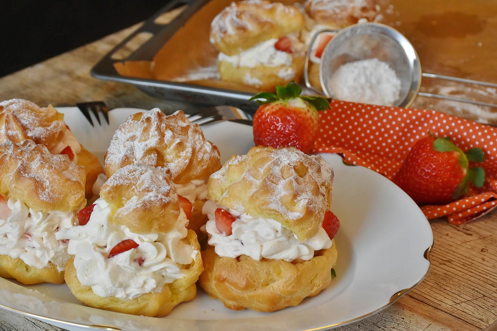 Cream Puffs and strawberries on a plate