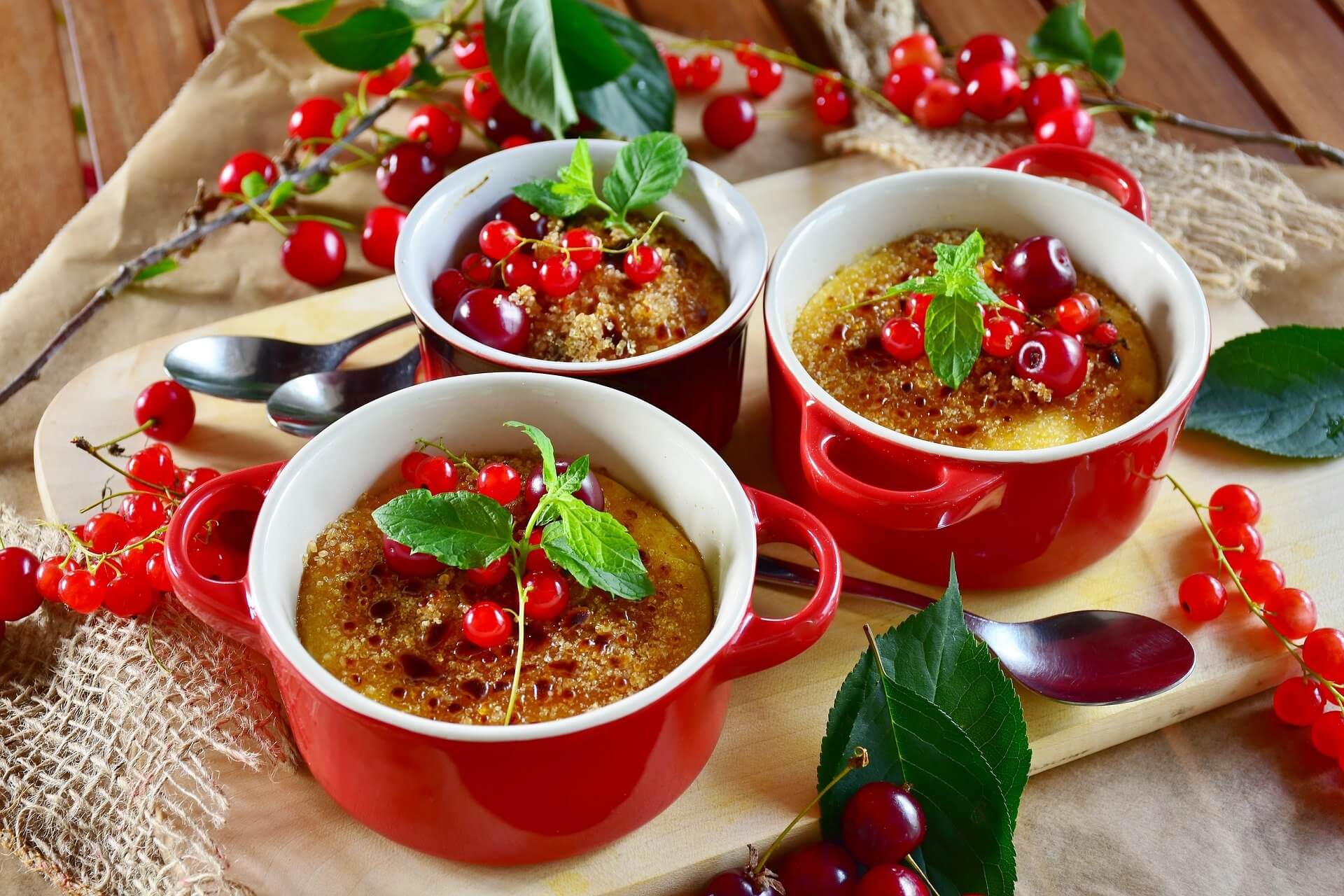 Mini pots of Creme Brule topped with red currents and mint leaves